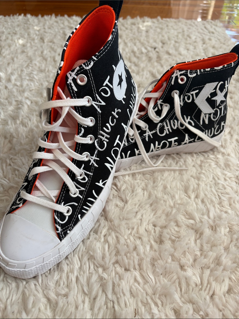 Converse “Not a Chuck” High Top Sneakers in Black with Orange Lining